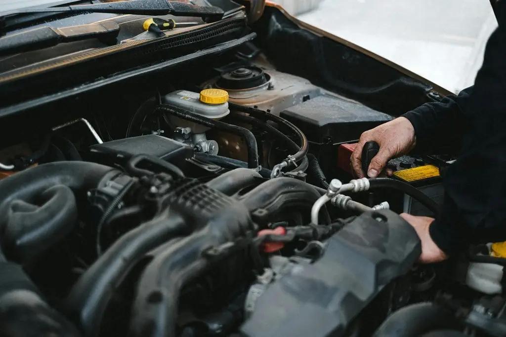ASE certified mechanic working on car engine at University Auto Service